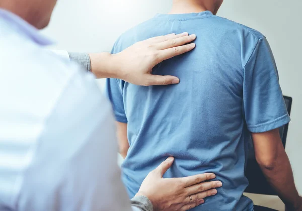 A patient receiving a back exam.