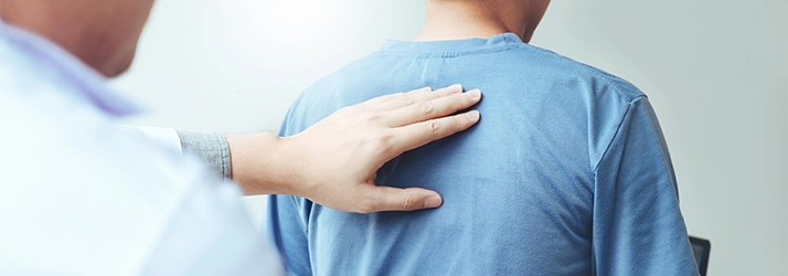 A chiropractor performing a back exam.