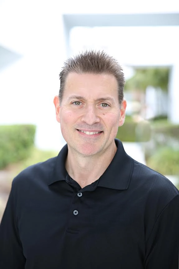 Dr. Scott Bourgeois smiling outside.