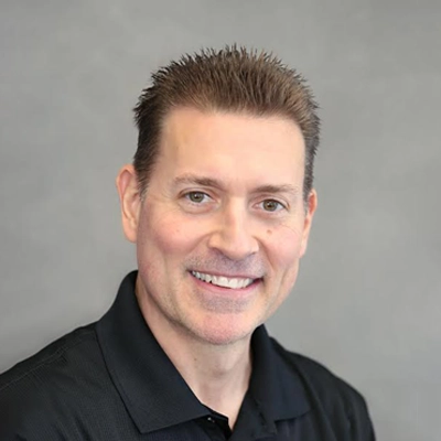 Dr. Scott Bourgeois smiling in a black shirt.